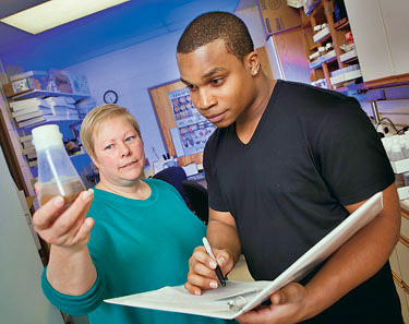 Elaine Reynolds, associate professor of biology, and Glenford Robinson ’13 are using epileptic flies to try and understand why a high-fat diet reduces the incidence of seizures in some people.