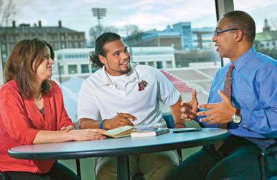 Susan Averett (left), Dana Professor of Economics, Andrew Holmes ’12, and George Bright, associate director of athletics, discuss sports management in a seminar room in Allan P. Kirby Sports Center.