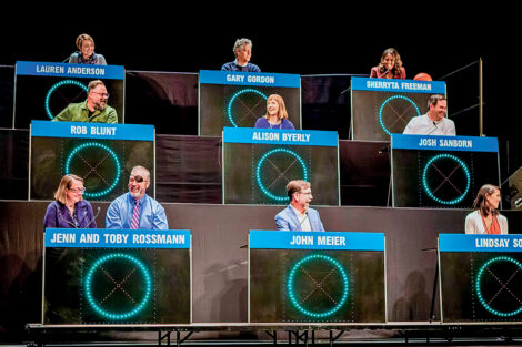 President Alison Byerly is seated as the center square in a Hollywood Squares game with other faculty and staff