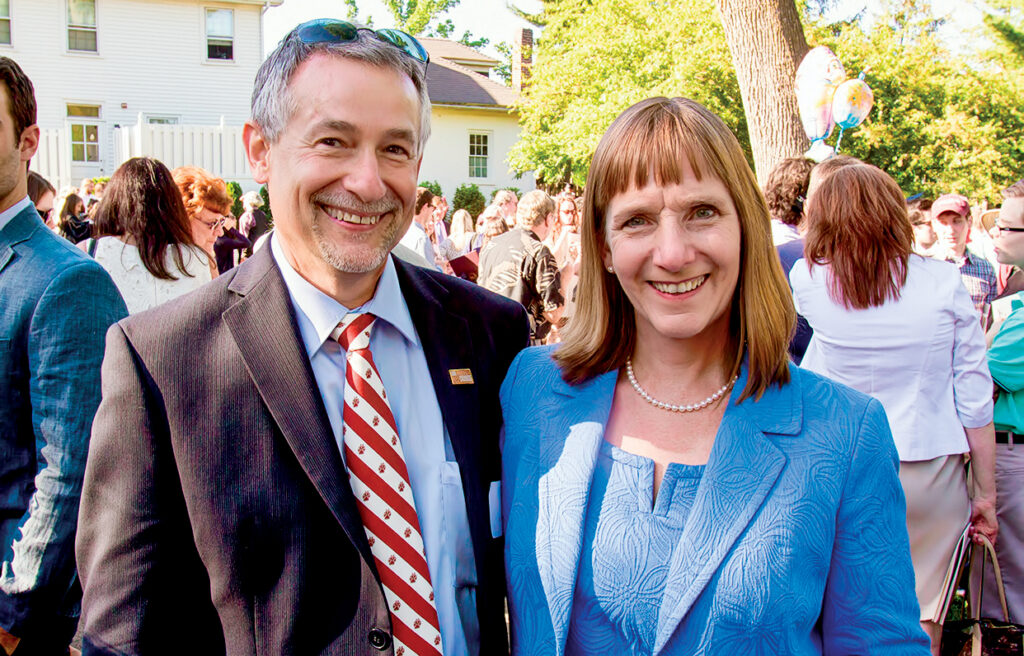 Alison Byerly and her husband, Steve Jensen, smile together as they host a post-Commencement celebration for students and families at their house.