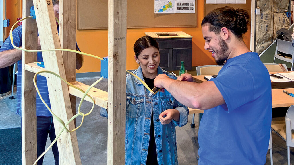 two students work on an electrical wiring project