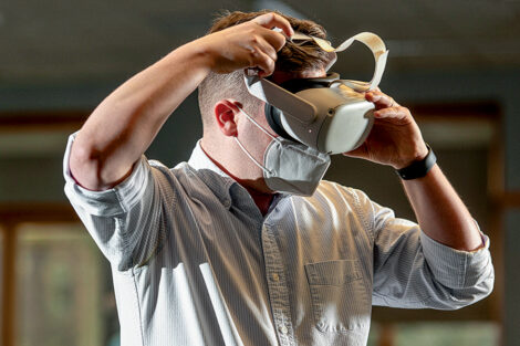 Eric Hupe, assistant professor of art history, puts on a VR headset to begin teaching a class.