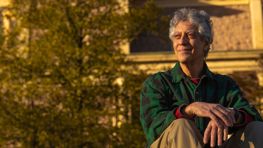 Gary Gordon sits outside, basked in warm light