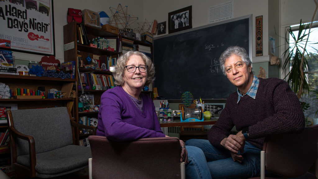 Liz McMahon and Gary Gordon sit in an office together