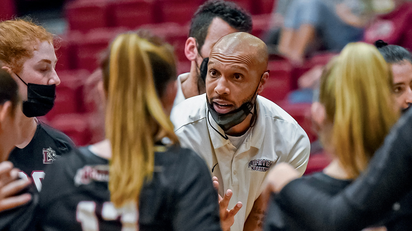 Ryan Adams talks to players on the sidelines