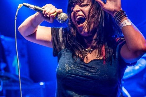 Dawn Botti sings into a microphone on stage